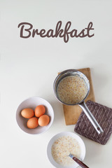 Breakfast with oatmeal and eggs. White table