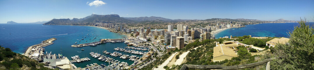 Fototapeta na wymiar Calpe Panorama. Panoramic view of Calpe from famous rock - Penon de Ifach, overlooking the coast, the harbor, lake and the city.