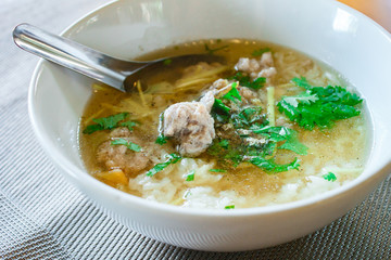 Boiled rice with pork in white bowl.