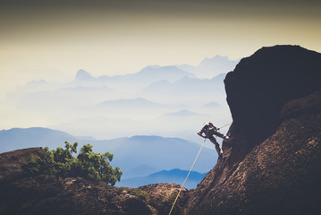 Climber against mountain valley. Instagram stylization