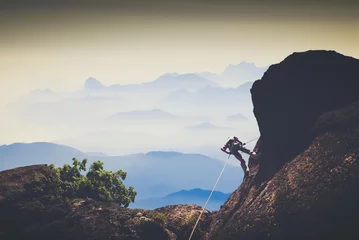 Gordijnen Alpinisme Climber against mountain valley. Instagram stylization  © Bashkatov