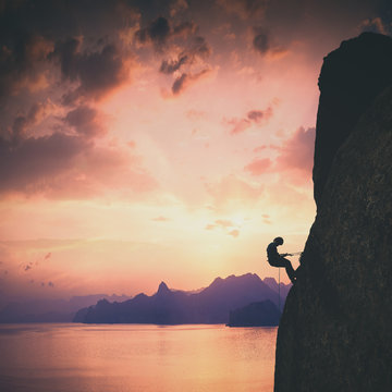 Climber against sunset. Instagram stylization