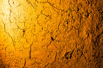 Clay wall in golden light as background