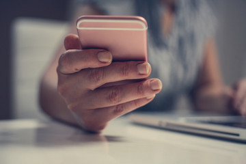 Close up of hand using smart phone. Caucasian business woman.