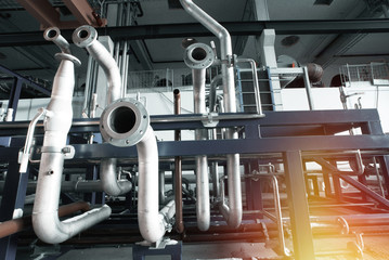 equipment, cables and piping as found inside of a modern industrial power plant