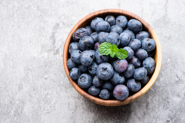 blueberry with vanilla mint in a wooden bowl on stone background ,top view

