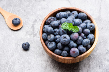 blueberry with vanilla mint in a wooden bowl on stone background ,top view
