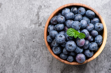 blueberry with vanilla mint in a wooden bowl on stone background ,top view
