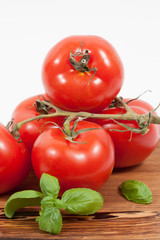 Mediterranean italien tomato with basil on wooden board