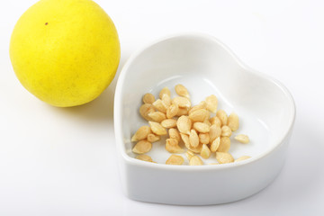 Lemon seeds are medicinal herbs on white.