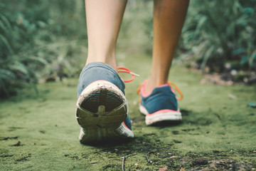 Feet of hipster girl walking in forest background, Relax time on holiday