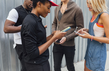 Group of Best Friends Using a Mobile Phone Outdoor. New York City Brooklyn US