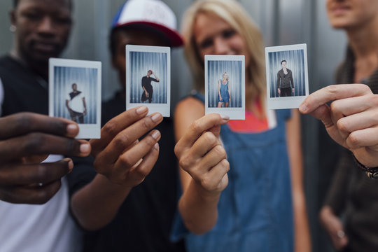 Group of Young People Showing their Picture . Individuality and Friendship concept