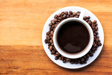 coffee cup and beans on the wood.