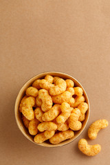 Peanut flips in a bowl viewed from above. Top view. Copy space