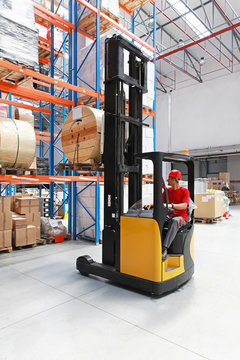 Forklift with cable spool in warehouse