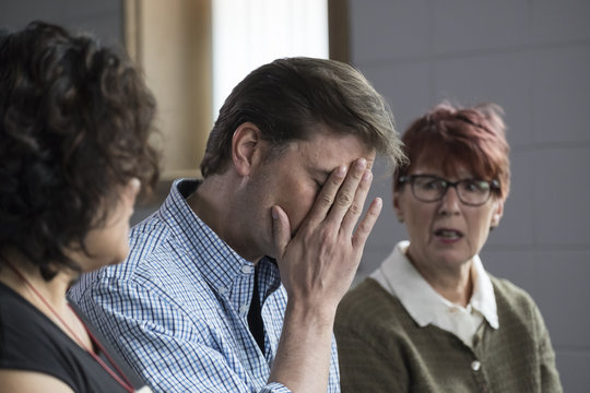 A man getting emotional in a small group meeting