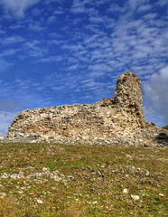 Beautiful landscape with ancient stone wall and blue sky