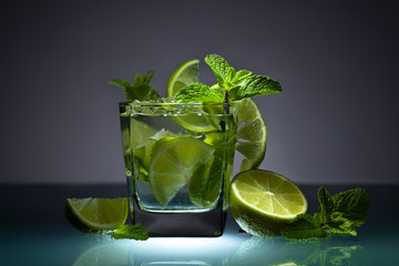 Cocktail with lime, ice and peppermint .