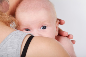 cute newborn baby on mothers shoulder