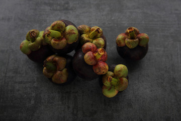 Mangosteen fruit on dark rock background