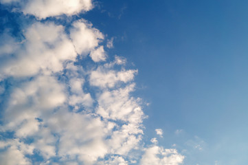 White cumulus clouds in the left of the blue sky