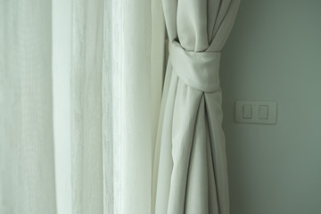 Curtain in cream color on window