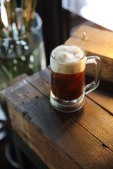 Coffee cocktail with coffee bean and rosemary on top with wood background