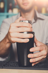Bartender shaking and mixing alcohol cocktail