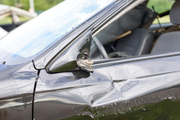 Damaged car with broken sideview mirror