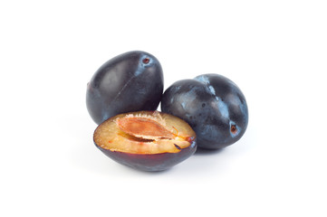 Blue plums on white background