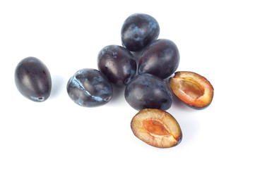 Blue plums on white background