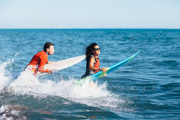 Young couple of surfers 