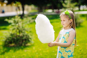girl with holding a wad of cotton candy