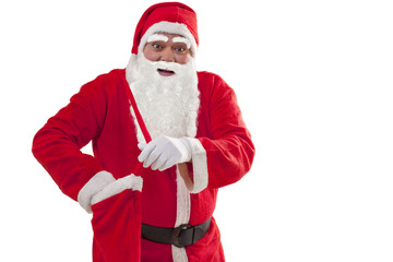 Portrait of Santa Claus removing gift from bag over white background 