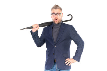 Elegant middle-aged businessman holding closed stick umbrella