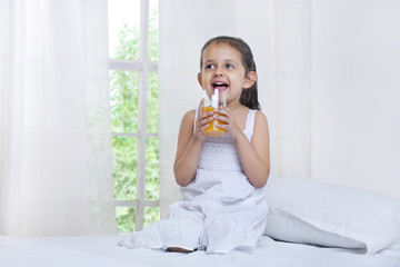 Cute little girl drinking juice 