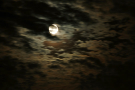 The moon in the cloudy night sky.