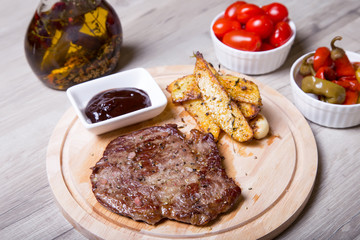 Marble beef with potatoes, tomatoes and pepperoni. Selective focus.