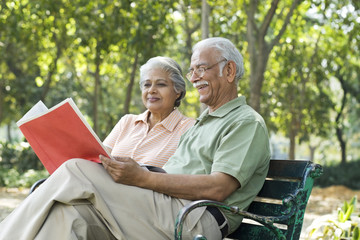 Old couple reading a document 