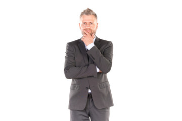 Portrait of middle-aged businessman in elegant suit posing against white background