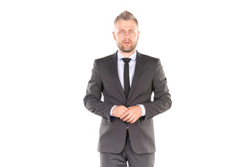 Portrait of middle-aged businessman in elegant suit posing against white background