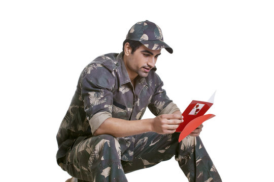 Smiling Soldier Reading Greeting Card 