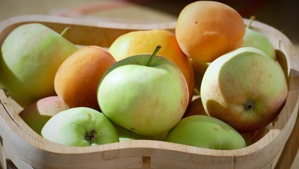 Organic apples in basket in summer grass. Fresh apples in nature 002