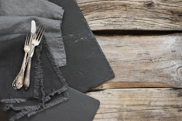 Grey kitchen utensils on rough distressed wooden table