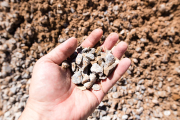Building crushed stone with sand in hand