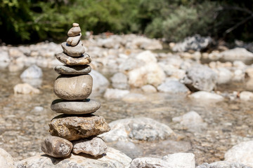 balancing stones on the mountain river