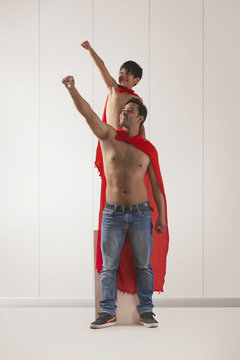Father and son acting as super heroes