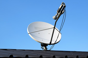 Satellite dish antenna with blue sky.