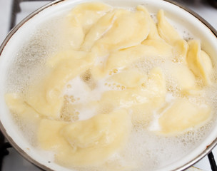 Vareniki with potatoes are cooked in a saucepan